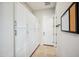 Bright hallway featuring floor to ceiling cabinetry and access to the garage at 10322 E Topaz Ave, Mesa, AZ 85212