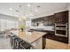 Well-appointed kitchen with granite countertops and a breakfast bar with stylish pendant lights at 10322 E Topaz Ave, Mesa, AZ 85212