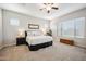 Relaxing main bedroom suite with a ceiling fan and large window at 10322 E Topaz Ave, Mesa, AZ 85212