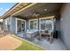 Relaxing covered patio area with comfortable seating and an outdoor dining set at 10322 E Topaz Ave, Mesa, AZ 85212