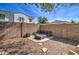 The cozy backyard fire pit area with stone accents provides a perfect setting for relaxation and outdoor gatherings at 10402 E Javelina Ave, Mesa, AZ 85209