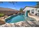 Inviting backyard pool with a rock waterfall feature, perfect for relaxing and enjoying the outdoors at 10402 E Javelina Ave, Mesa, AZ 85209