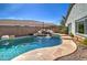 Sparkling backyard pool with rock features and mature landscaping, perfect for hot summer days at 10402 E Javelina Ave, Mesa, AZ 85209