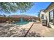 Beautiful backyard pool featuring a rock waterfall, surrounded by lush landscaping at 10402 E Javelina Ave, Mesa, AZ 85209
