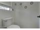 Clean bathroom featuring a standard toilet with neutral wall decor and natural light at 10402 E Javelina Ave, Mesa, AZ 85209