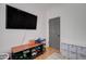 Guest bedroom with hardwood floors and a media center at 10402 E Javelina Ave, Mesa, AZ 85209