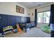 This bedroom features bright white walls, blue wall accents, and carpet flooring at 10402 E Javelina Ave, Mesa, AZ 85209