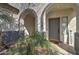 Inviting front porch with stone accents, a dark front door, and a decorative welcome sign at 10402 E Javelina Ave, Mesa, AZ 85209
