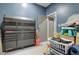 Organized garage with a large tool chest, storage solutions, and a functional workspace at 10402 E Javelina Ave, Mesa, AZ 85209
