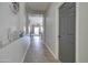 Neutral hallway with tile flooring that leads to a sunlit living room at 10402 E Javelina Ave, Mesa, AZ 85209