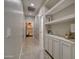 Hallway with built-in shelving units for storage and decorative display at 10402 E Javelina Ave, Mesa, AZ 85209