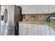 Modern kitchen features stainless steel appliances, white cabinets, and attractive countertops at 10402 E Javelina Ave, Mesa, AZ 85209