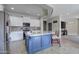 Modern kitchen with an island, white cabinetry, stainless steel appliances, and granite countertops at 10402 E Javelina Ave, Mesa, AZ 85209