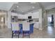 Spacious kitchen boasting white cabinets, stainless steel appliances, and a stylish center island at 10402 E Javelina Ave, Mesa, AZ 85209