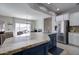 Stylish kitchen island featuring stone countertops, providing a gathering spot and ample workspace at 10402 E Javelina Ave, Mesa, AZ 85209