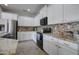 Modern kitchen featuring stainless steel appliances, white cabinets, and tiled backsplash at 10402 E Javelina Ave, Mesa, AZ 85209