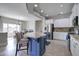 Open-concept kitchen with a large island, stainless steel appliances, and seamlessly connects to the dining area at 10402 E Javelina Ave, Mesa, AZ 85209