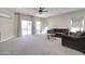 Large, carpeted living room with neutral walls, recessed lighting and sliding glass door to backyard at 10402 E Javelina Ave, Mesa, AZ 85209