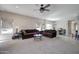 Spacious living room with large window and ceiling fan, perfect for entertaining at 10402 E Javelina Ave, Mesa, AZ 85209