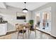 Bright dining room featuring round table, four chairs, and double doors leading to the outside at 10424 N 7Th Pl # 2, Phoenix, AZ 85020
