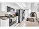 Bright kitchen with stainless steel appliances including refrigerator, oven, microwave, and a convenient washer and dryer at 10424 N 7Th Pl # 2, Phoenix, AZ 85020