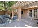 Charming outdoor patio with string lights, comfortable seating, and a wall-mounted TV at 10424 N 7Th Pl # 2, Phoenix, AZ 85020