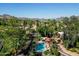 Scenic community pool, surrounded by towering palm trees and lush greenery at 10424 N 7Th Pl # 2, Phoenix, AZ 85020