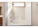 Full bathtub and shower featuring a small above the shower window allowing for natural light to illuminate the space at 10923 W Ivory Ln, Avondale, AZ 85392