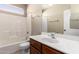 Bathroom featuring single sink with vanity, mirror, and tiled shower and tub combo at 10923 W Ivory Ln, Avondale, AZ 85392