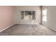 Bedroom with neutral carpet, large window, and vertical blinds for privacy at 10923 W Ivory Ln, Avondale, AZ 85392