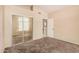 Bedroom featuring mirrored closet doors and neutral walls at 10923 W Ivory Ln, Avondale, AZ 85392