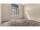 Bedroom with carpet floors, neutral wall paint, a large window and ample natural light at 10923 W Ivory Ln, Avondale, AZ 85392