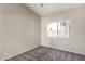 Bedroom with neutral walls, carpet, and a window for natural light at 10923 W Ivory Ln, Avondale, AZ 85392