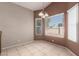 Bright dining room featuring tile floors, neutral paint, and updated lighting at 10923 W Ivory Ln, Avondale, AZ 85392