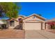 Charming single-story home with a two-car garage and a well-maintained front yard at 10923 W Ivory Ln, Avondale, AZ 85392