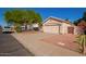 Charming home with a large front yard, two-car garage, and mature tree at 10923 W Ivory Ln, Avondale, AZ 85392