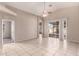 Bright living room featuring tile floors, neutral walls, and sliding glass doors to backyard at 10923 W Ivory Ln, Avondale, AZ 85392