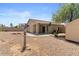 Spacious backyard featuring a patio area, desert landscaping, and privacy fencing at 13796 W Mauna Loa Ln, Surprise, AZ 85379