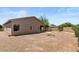 Spacious backyard with desert landscaping and a covered patio, perfect for outdoor living at 13796 W Mauna Loa Ln, Surprise, AZ 85379