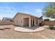 View of the covered patio and gravel landscaping, creating a serene outdoor space at 13796 W Mauna Loa Ln, Surprise, AZ 85379