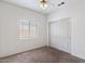 Comfortable carpeted bedroom with a window and closet space for storage at 13796 W Mauna Loa Ln, Surprise, AZ 85379