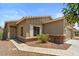 Charming home with brick accents, a two-car garage, and desert landscaping at 13796 W Mauna Loa Ln, Surprise, AZ 85379