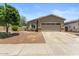 Charming single-story home featuring desert landscaping and a two-car garage at 13796 W Mauna Loa Ln, Surprise, AZ 85379