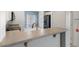 Bright kitchen featuring stainless steel appliances, a breakfast bar, and laminate flooring at 13796 W Mauna Loa Ln, Surprise, AZ 85379