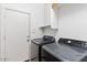A clean and functional laundry area with modern washer and dryer units at 13796 W Mauna Loa Ln, Surprise, AZ 85379