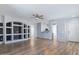 Large living area with wood flooring, recessed lighting, and a decorative built-in wall unit at 13796 W Mauna Loa Ln, Surprise, AZ 85379