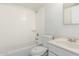 A bright bathroom with a tub, shower, toilet, and sink at 1512 W Crescent Ave, Mesa, AZ 85202