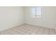 Bright bedroom featuring tile floors and a window with blinds for natural light at 1512 W Crescent Ave, Mesa, AZ 85202