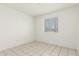 Bright bedroom featuring tile floors and a window for natural light at 1512 W Crescent Ave, Mesa, AZ 85202