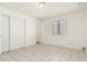 Neutral bedroom featuring tile floors and window at 1512 W Crescent Ave, Mesa, AZ 85202